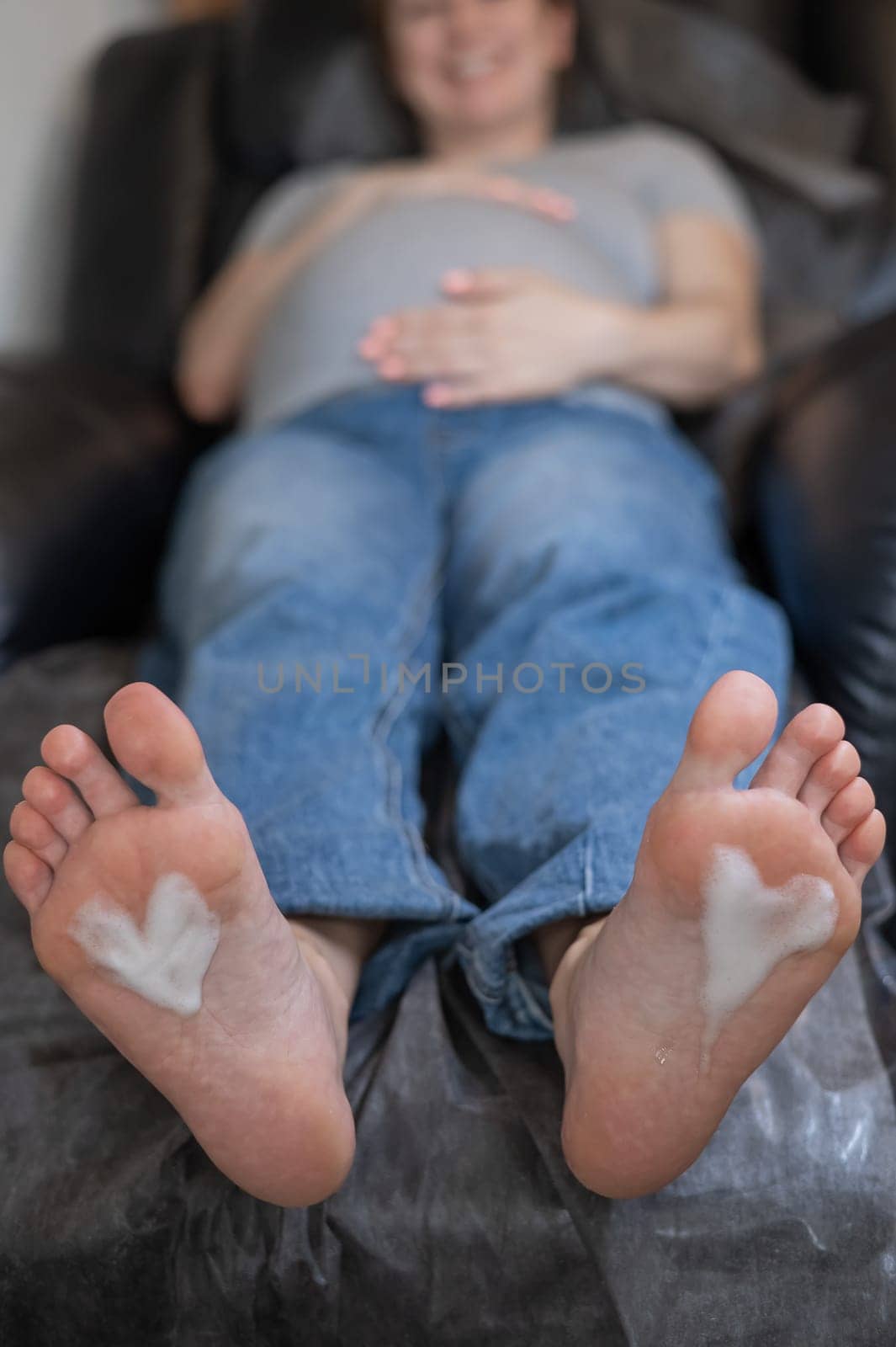 Pregnant woman on a hardware pedicure procedure in a beauty salon