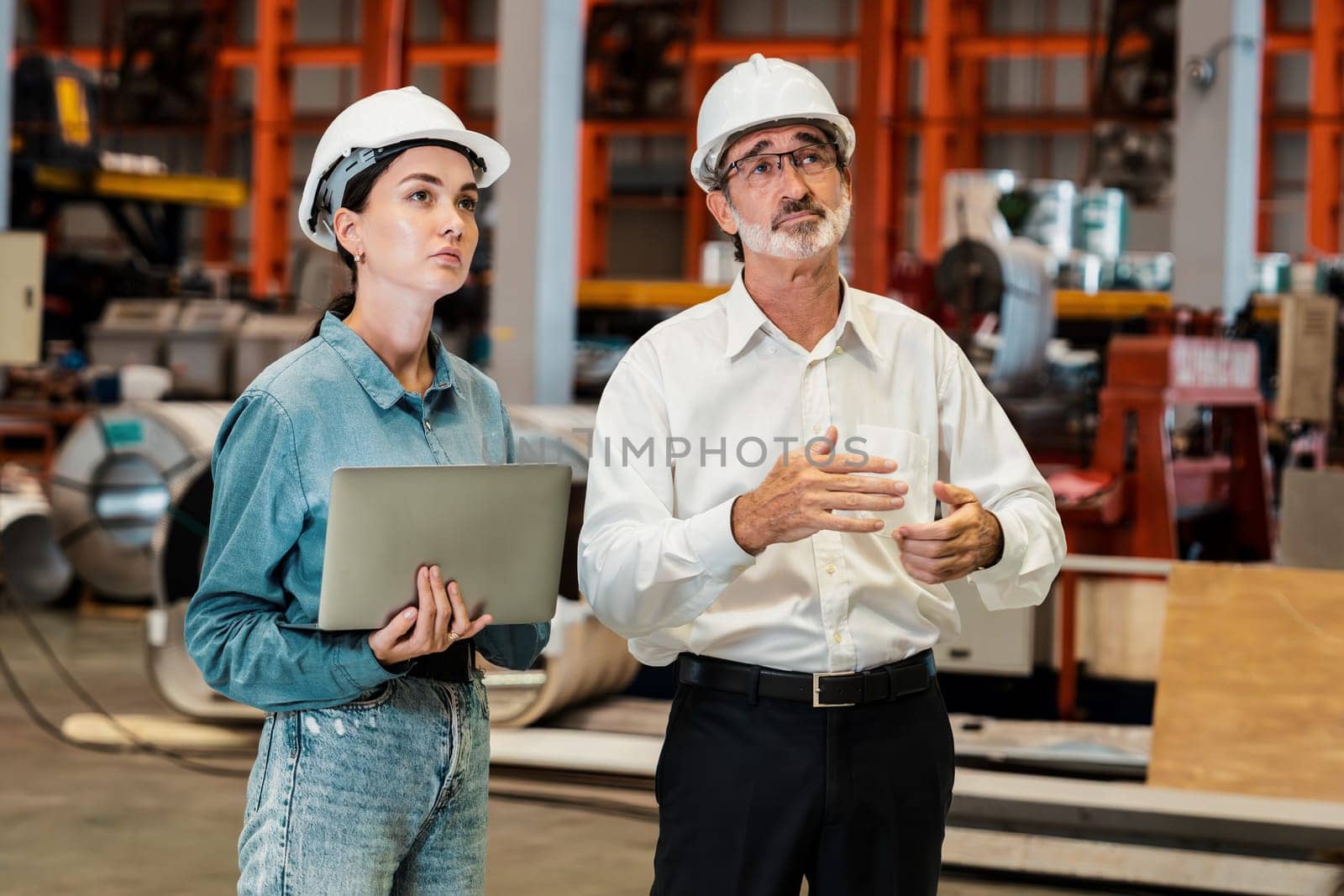 Factory manager or executive make visit metalwork manufacturing factory tour and inspect heavy steel industrial machinery showcase leadership quality as engineering inspection supervisor. Exemplifying