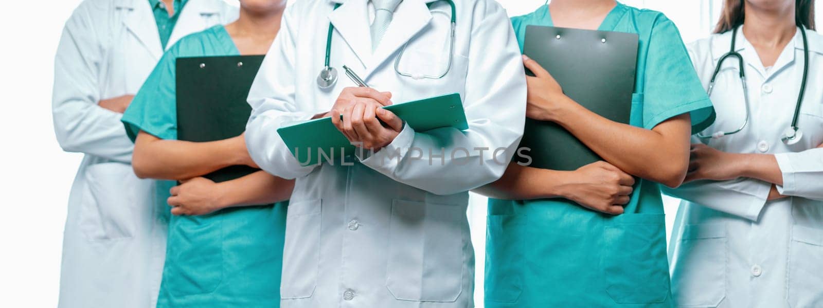 Confident medical staff team with doctor nurse and healthcare specialist professions people in hospital or clinic office. Medical and healthcare community in panoramic banner. Neoteric