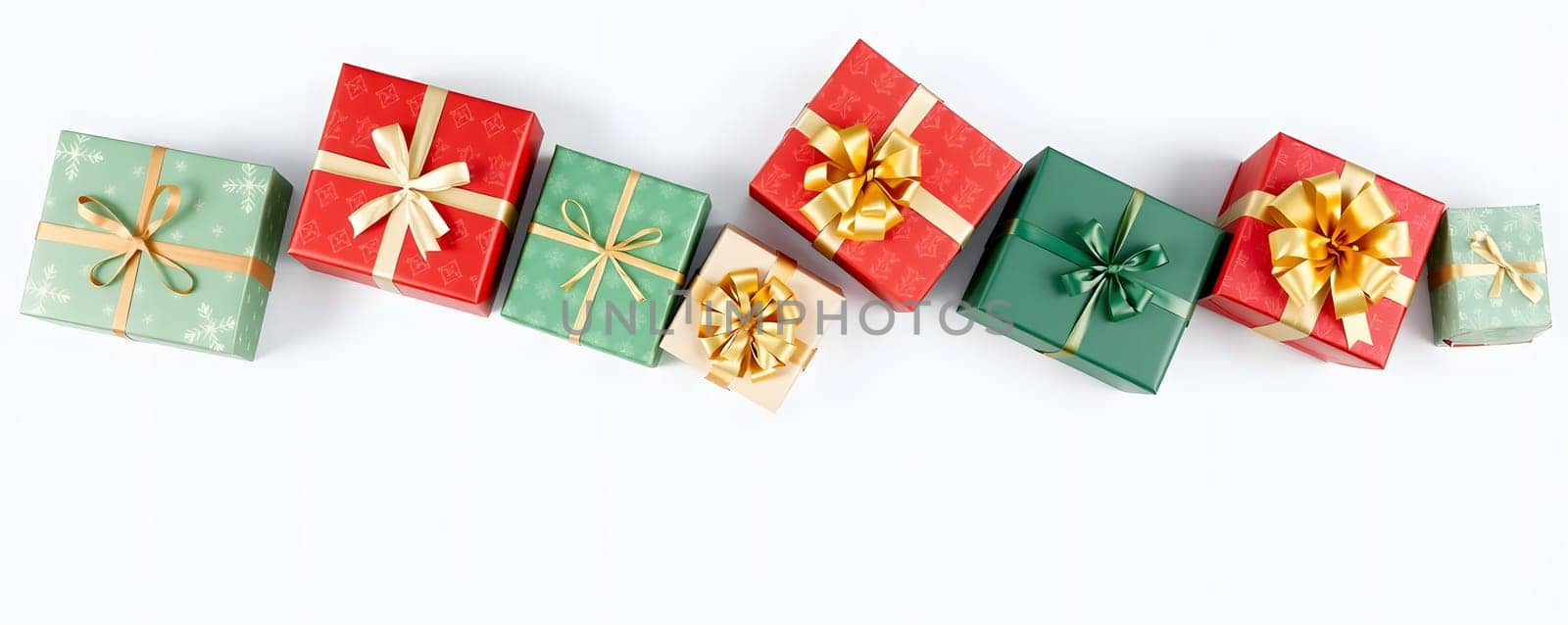 A variety of wrapped gift boxes in green and red, adorned with ribbons and bows, are arranged artistically. These festive packages add a cheerful touch to any holiday setting.