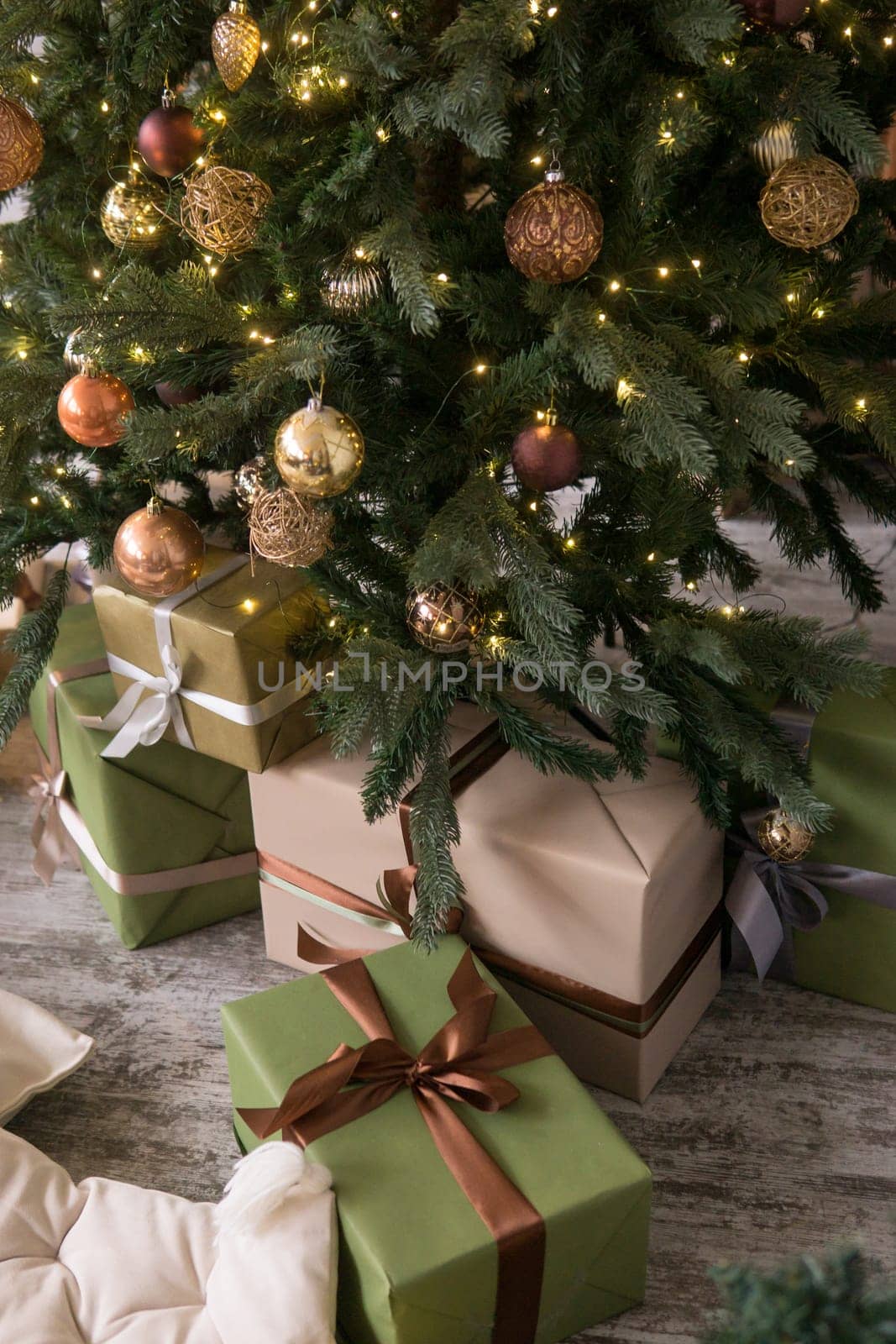 Bronze balls on the Christmas tree close-up. Christmas tree design decorations. The concept of celebrating New Year and Christmas