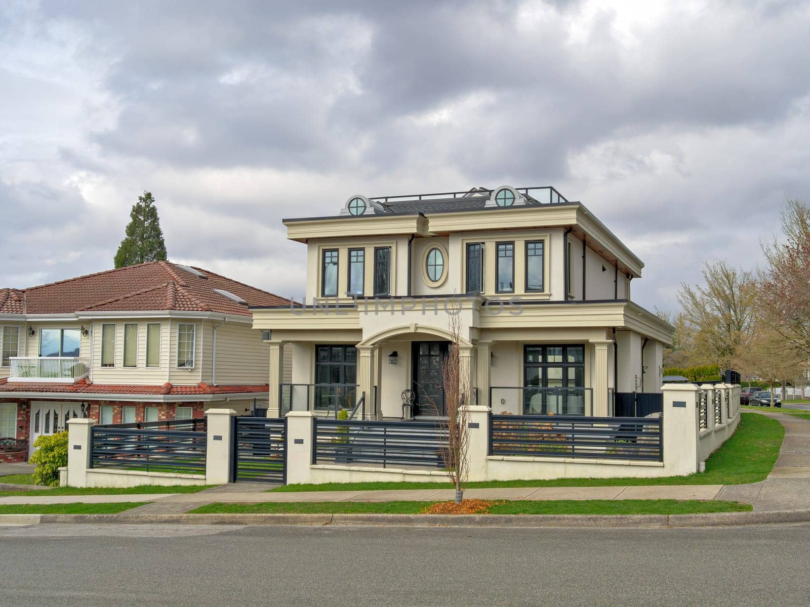 The street corner with residential houses on overcast sky background.