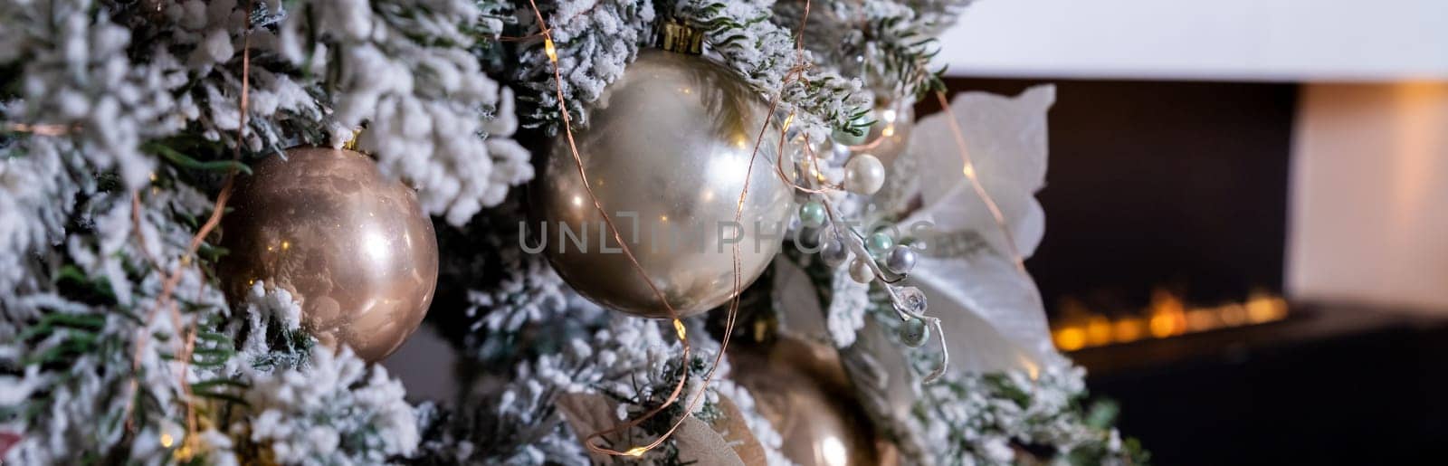 Golden textured ornament on the Christmas tree with bokeh lights background. Christmas and New Year concept