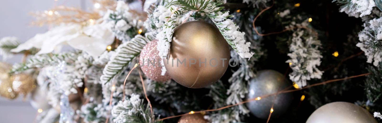 Golden textured ornament on the Christmas tree with bokeh lights background. Christmas and New Year concept
