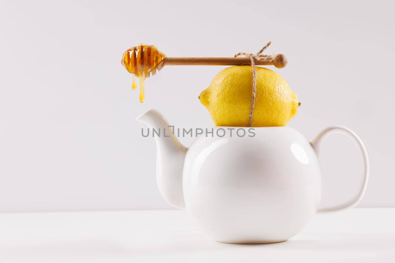 honey spoon with spilled honey on white background, top view, honey benefits concept