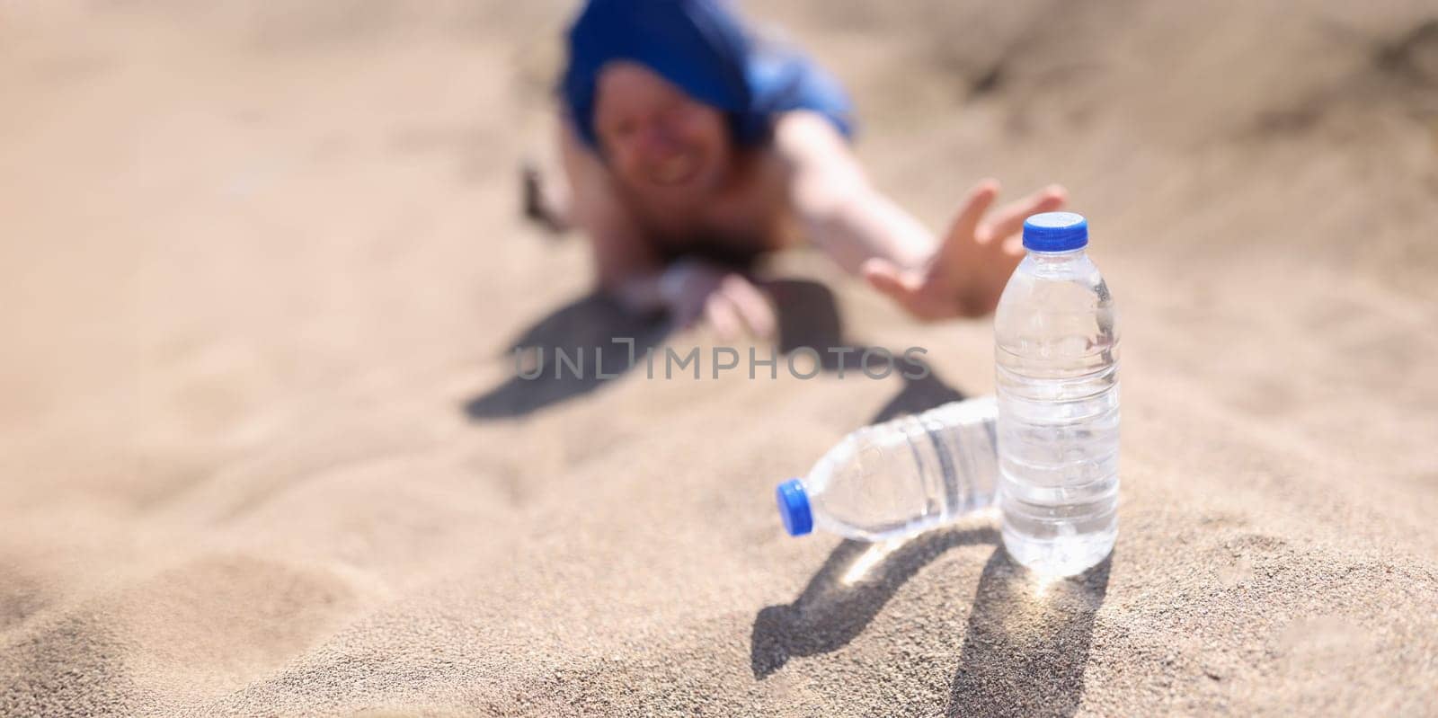 A man in the desert reaches for water bottles, close-up, blurry. Intense thirst for water, heat, dehydration