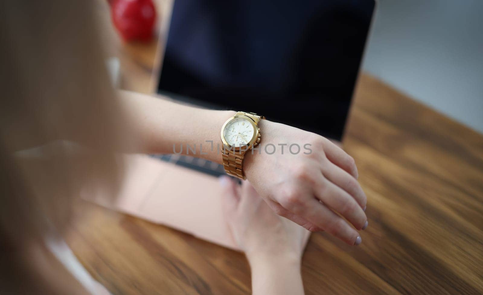 Close-up of office worker woman look at time on wristwatch and wait end of shift. Female late and check time, in rush home. Job, accessory, timing concept