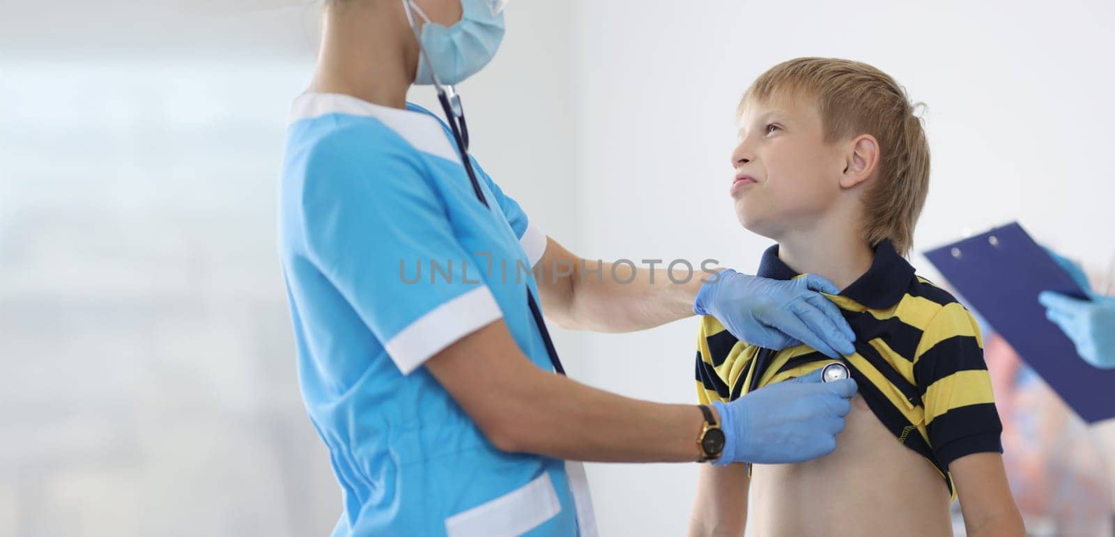 Portrait of female pediatrician listening to boy kid breathing with stethoscope tool, appointment at doctor. Checkup, clinic, healthcare, childhood concept