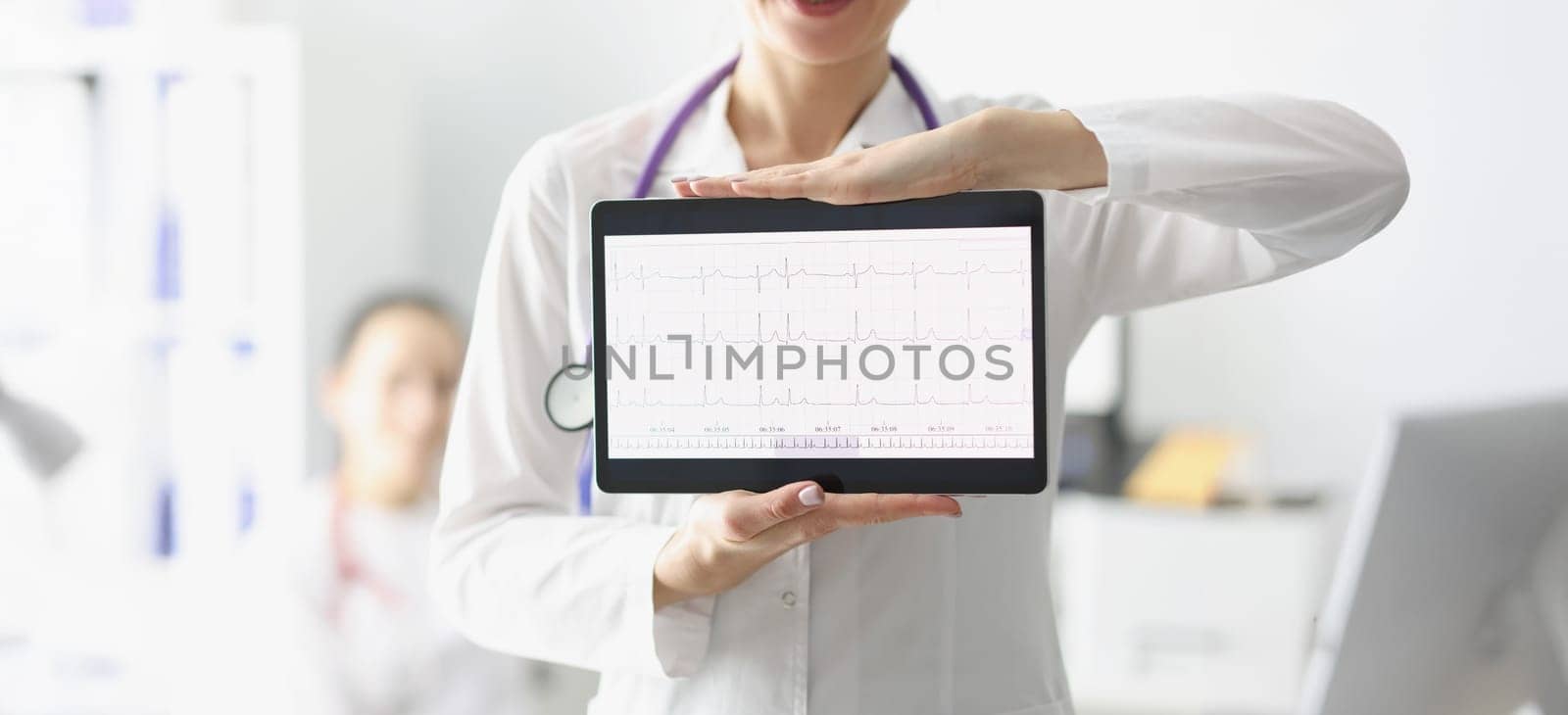 Close-up of doctor showing digital tablet screen with heart cardiogram result. Examination of cardiovascular system. Medicine, cardiology, health concept