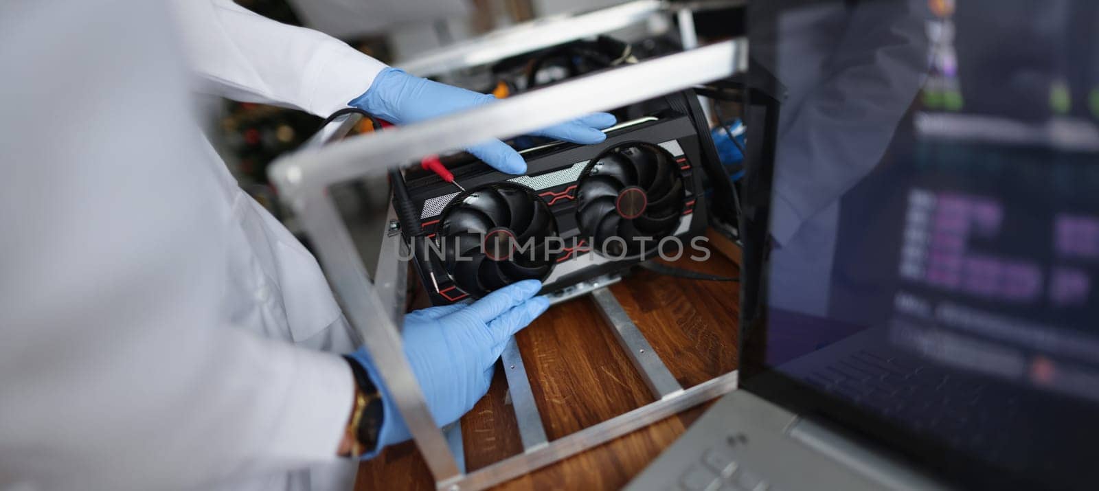 Close-up of man mechanic installing cooler fan with copper tubes on computer processor. Computer motherboard with all details. Technology, repair concept