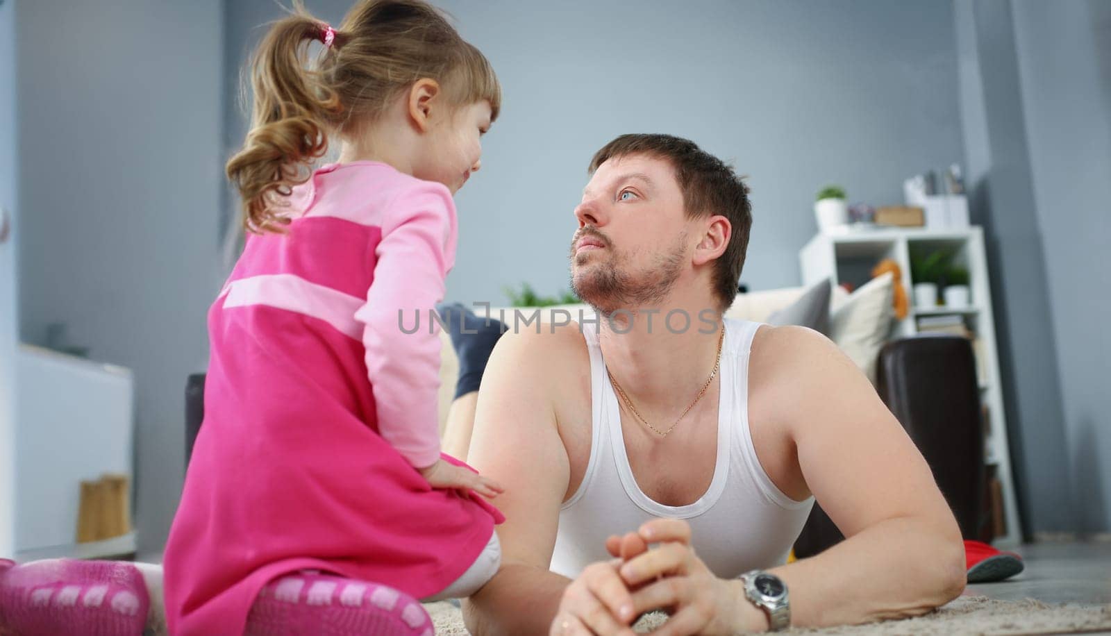 Portrait of father and daughter spending time together at home on holiday. Child spend quality time with parent. Childhood, parenthood, leisure concept