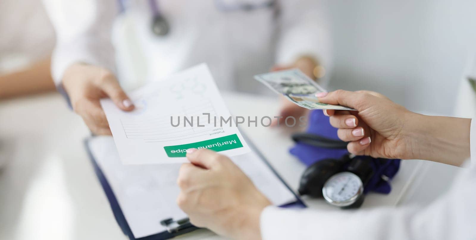 Close-up of patient give banknote money to doctor for marijuana recipe in hospital. Paper with hemp prescription. Alternative medicine, treatment concept