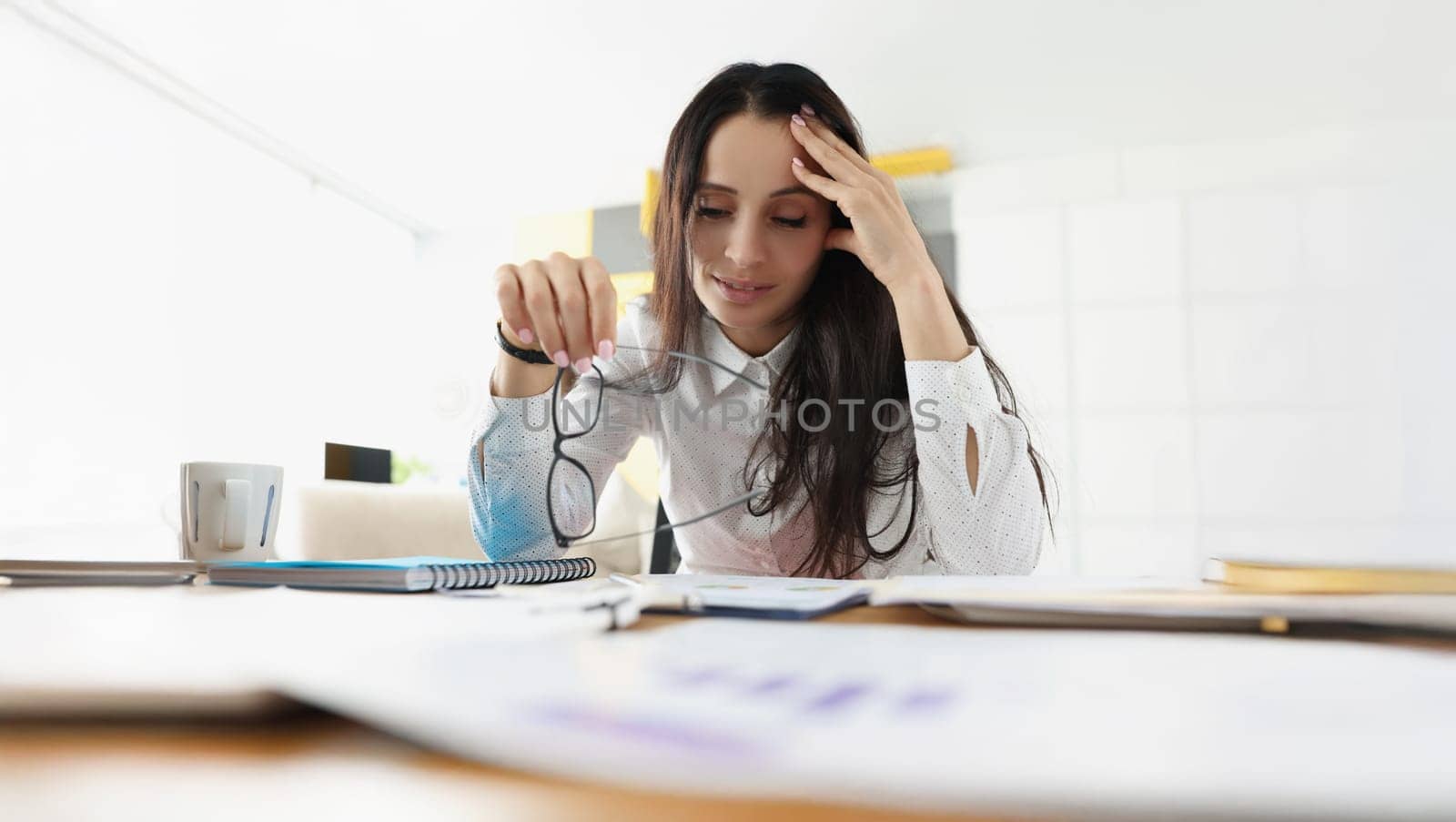 Portrait of tired overworked woman suffer with headache on workplace in office. Stressful and exhausted clerk in office. Hardworker, businesswoman concept