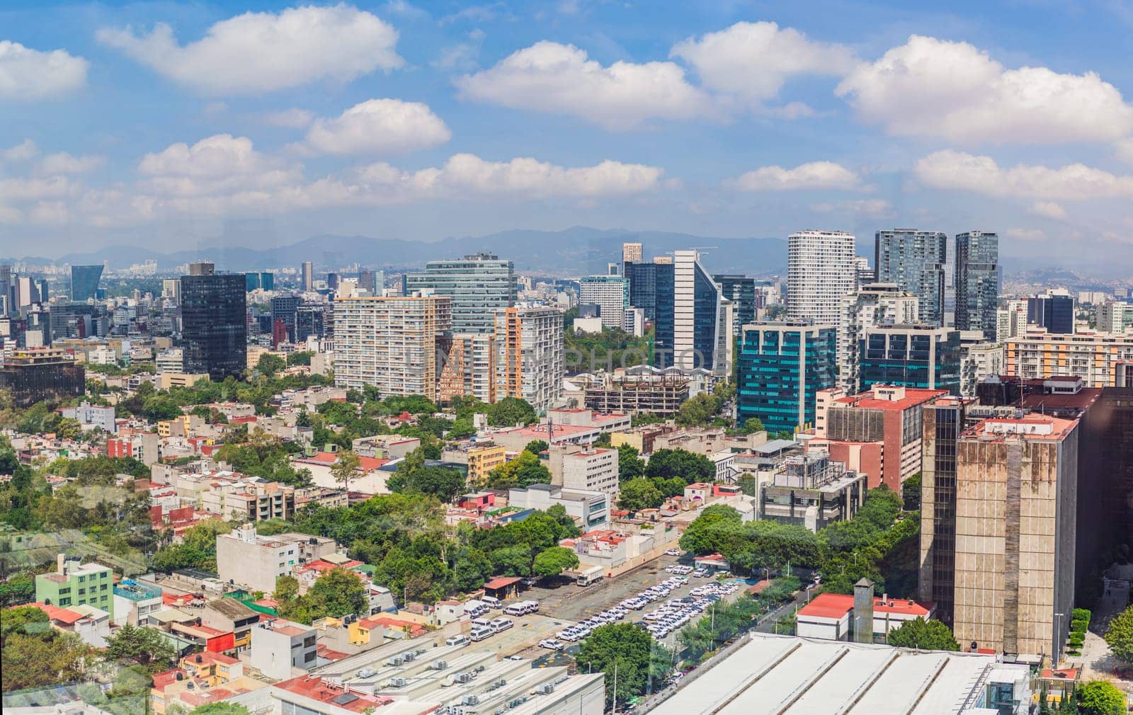 Panoramic view of Mexico City from above, showcasing the sprawling urban landscape, iconic landmarks, and vibrant culture. Cityscape, travel, and architecture concept.