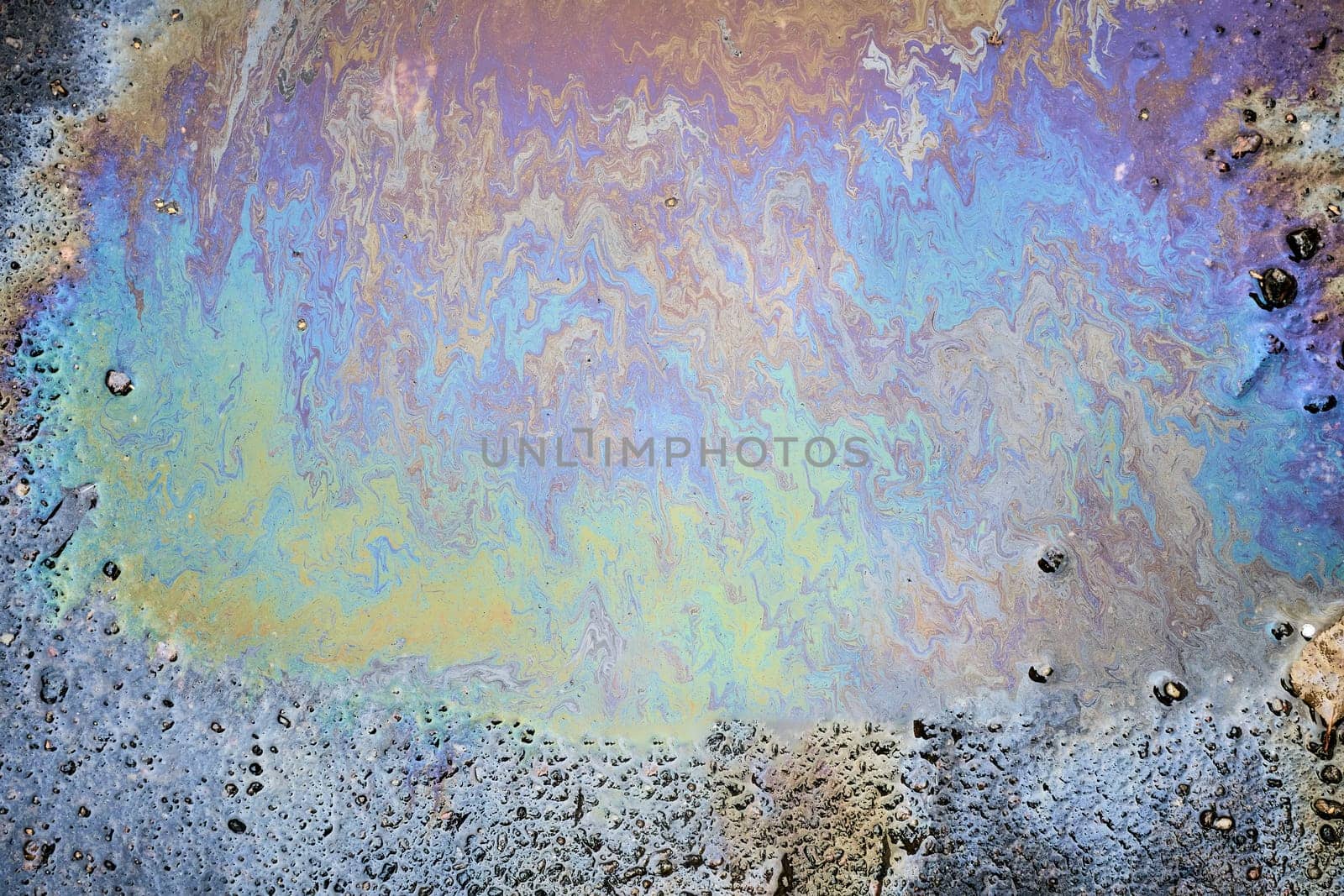 Abstract Oil Slick on Asphalt with Rainbow Colors.