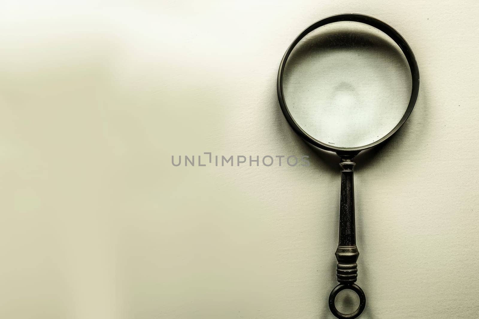 Close up of a magnifying glass isolated on a clean white background for clarity and focus