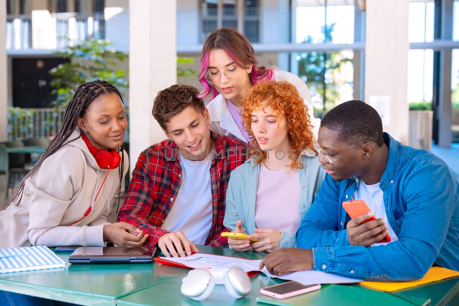 Multiracial college assignments and learning classes studying sitting around the university campus.
