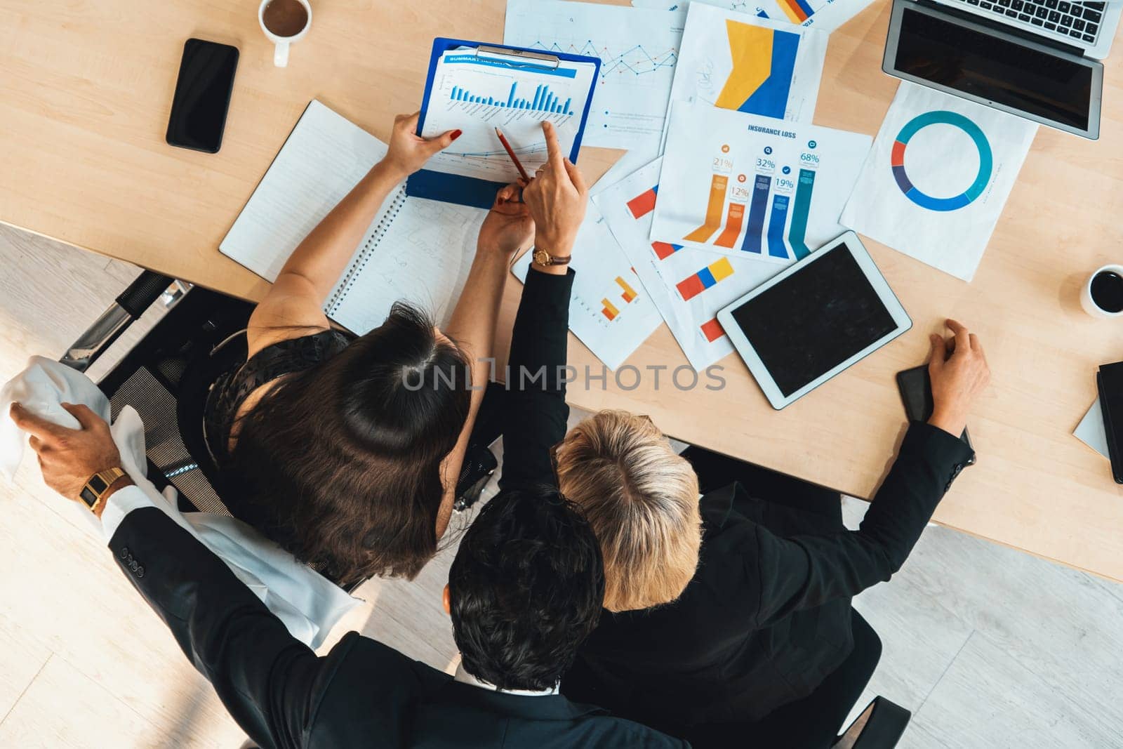 Business people group meeting shot from top view in office . Profession businesswomen, businessmen and office workers working in team conference with project planning document on meeting table . Jivy