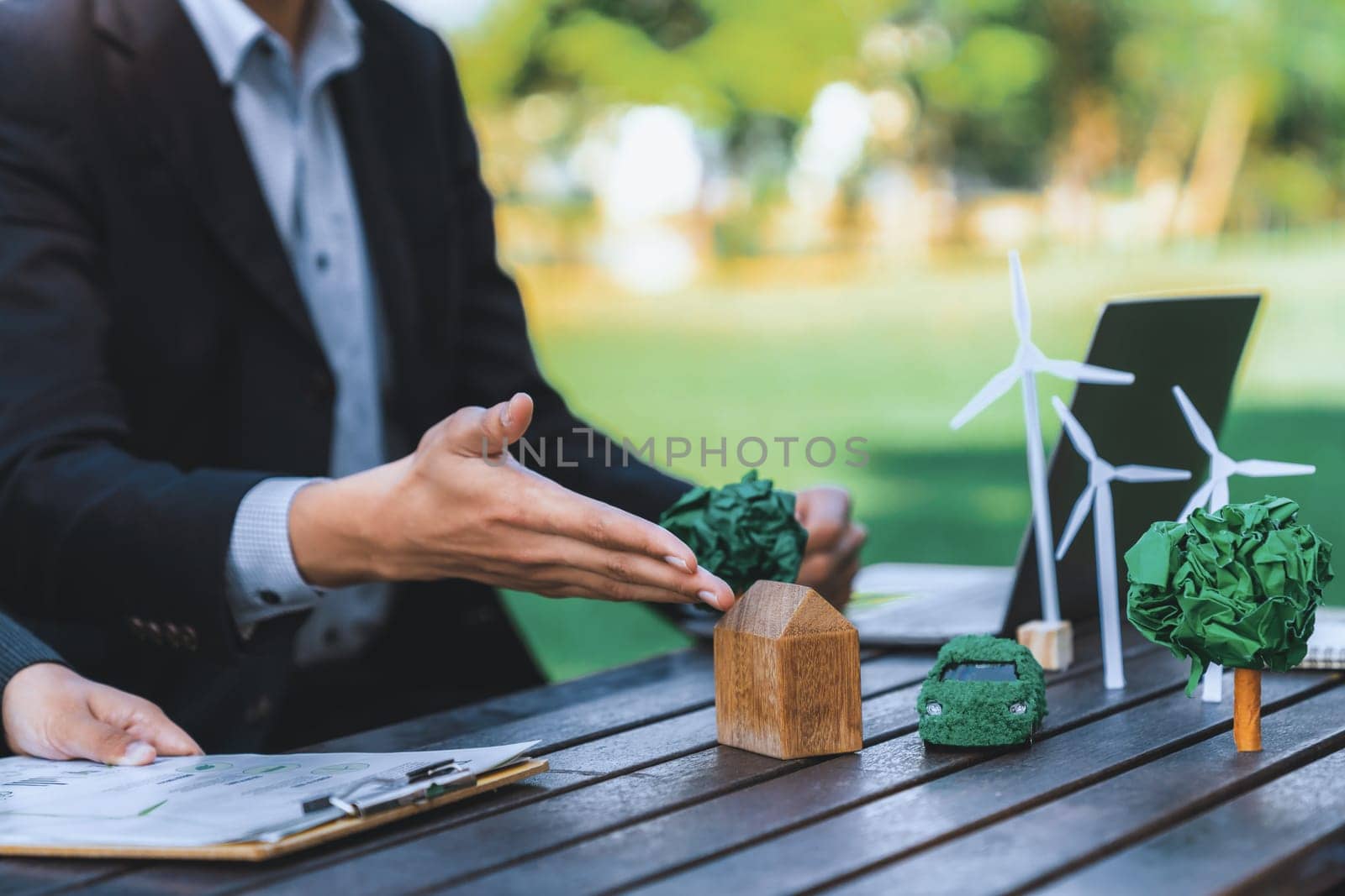 Group of asian business people presenting environmentally friendly development plan and sustainable technology project for greener future, establishing outdoor eco business office at natural park.Gyre