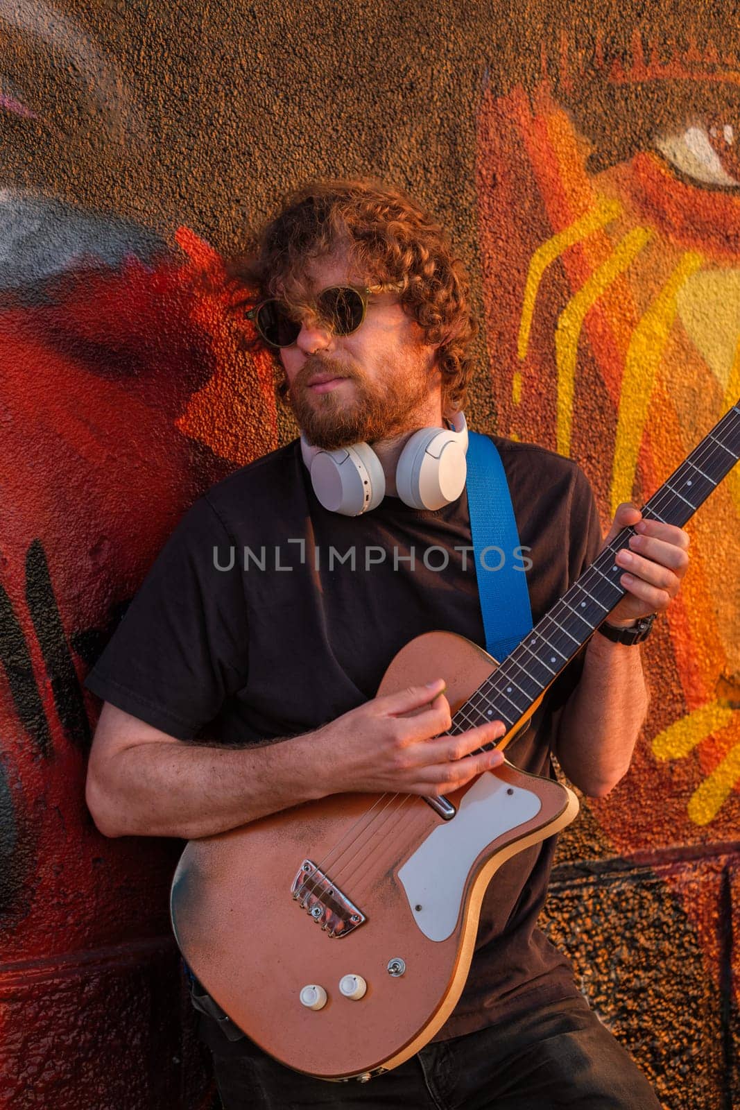 Street musician playing electric guitar in the street by dimol