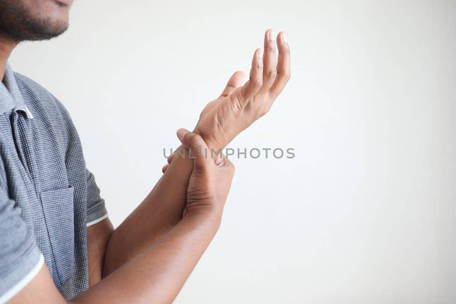 man suffering pain in hand close up .