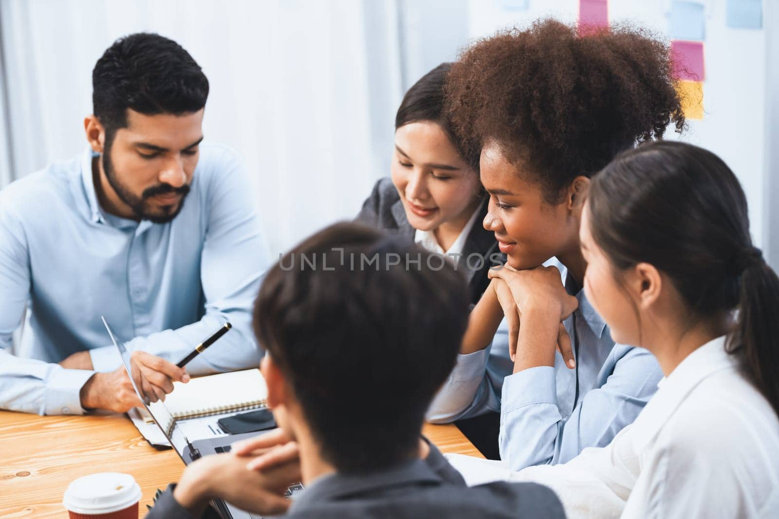 Multiracial analyst team use BI dashboard data to analyze financial report on meeting table. Group of diverse business people utilize data analysis by FIntech for success business marketing. Concord