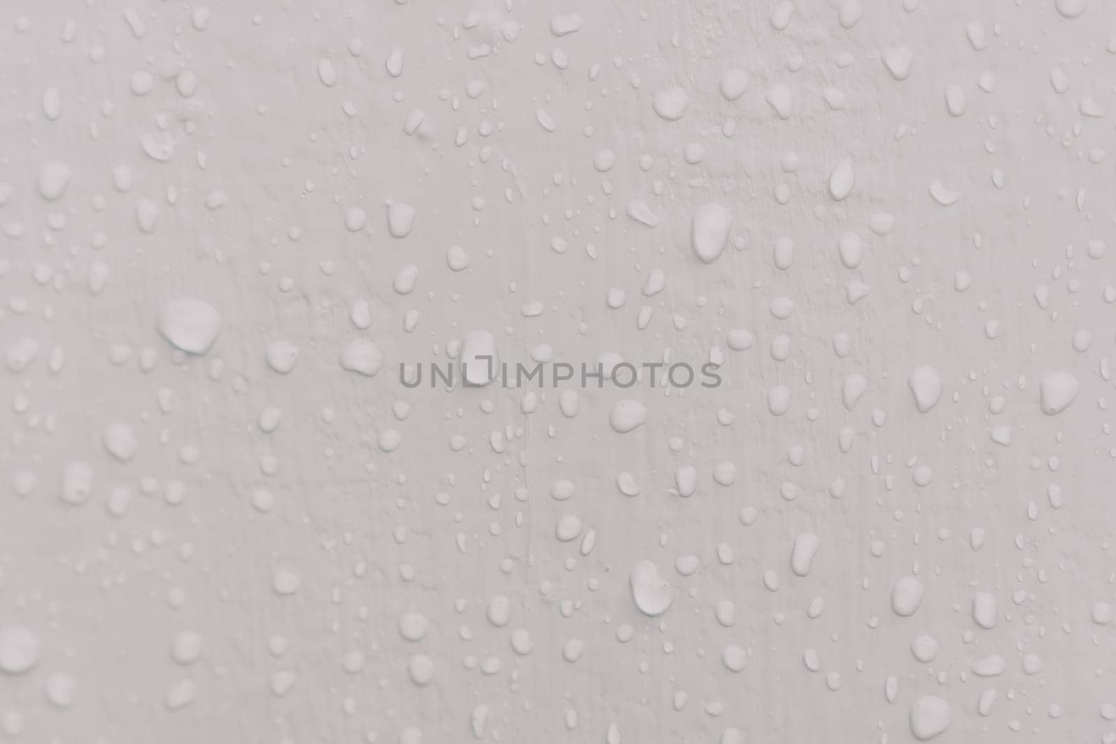 Water drops an gray surface. Abstract water drops background. by panophotograph