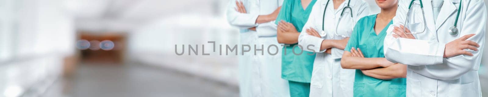 Confident medical staff team with doctor nurse and healthcare specialist professions people in blurry hospital corridor background. Medical and healthcare community in panoramic banner. Neoteric