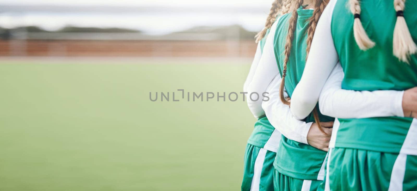 Women, fitness team and huddle with back on sport field with mockup space outdoor. Arms linked, solidarity and workout together with friends and training for exercise and game with support and unity.