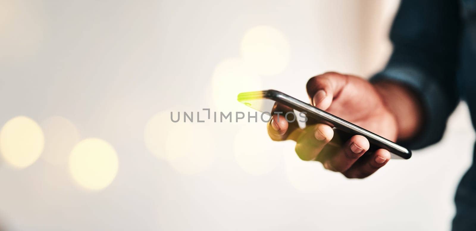 Businessman, hand and smartphone in closeup for communication in overlay, bokeh and banner for mockup. Black, person or worker for digital marketing, social media or fintech in office on internet by YuriArcurs