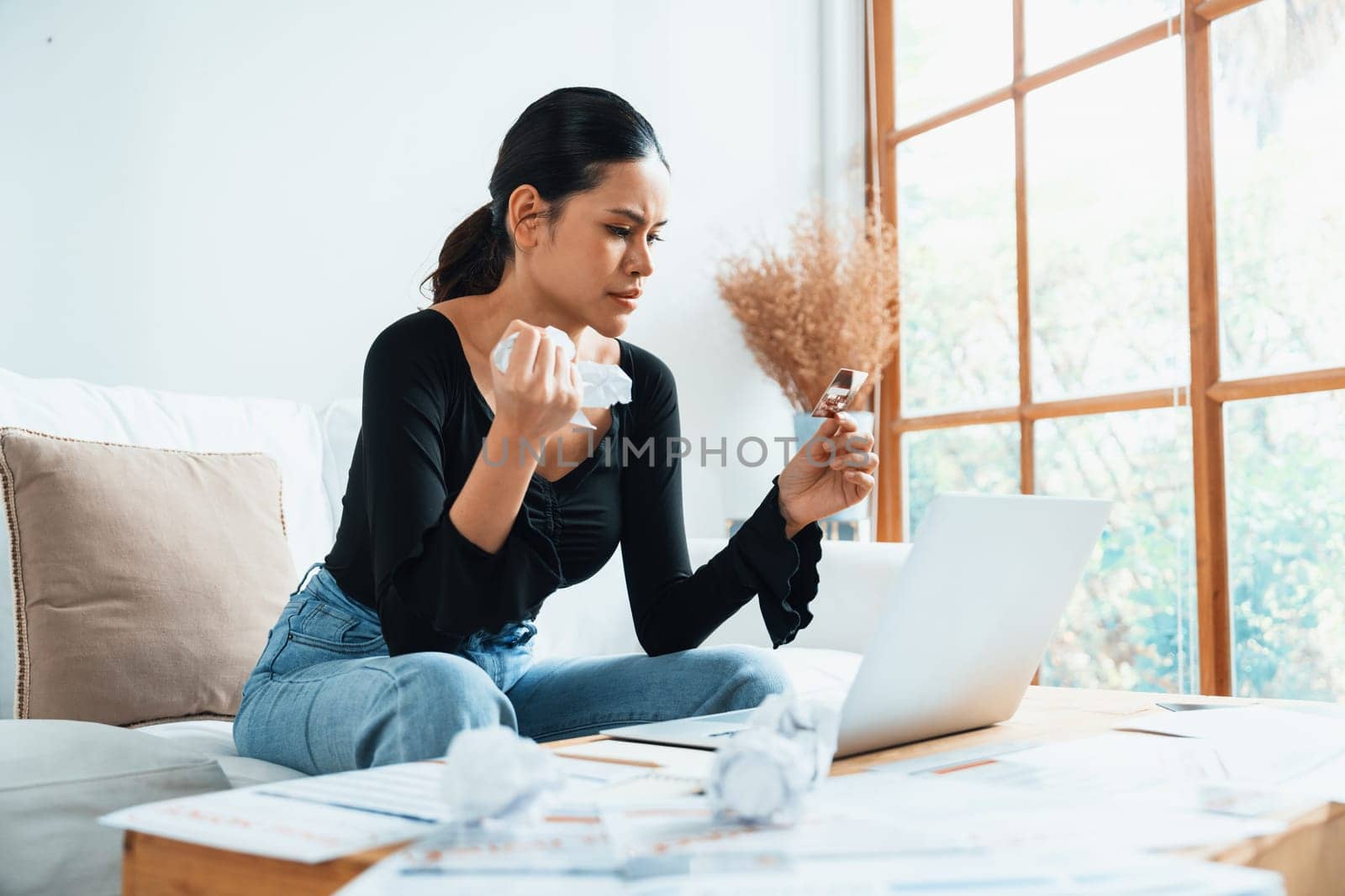 Stressed young woman has financial problems with credit card debt to pay uttermost show concept of bad personal money and mortgage pay management crisis.