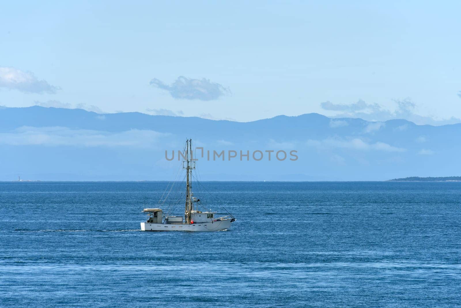 Small trawler is going to the fishing reid in Pacific ocean.