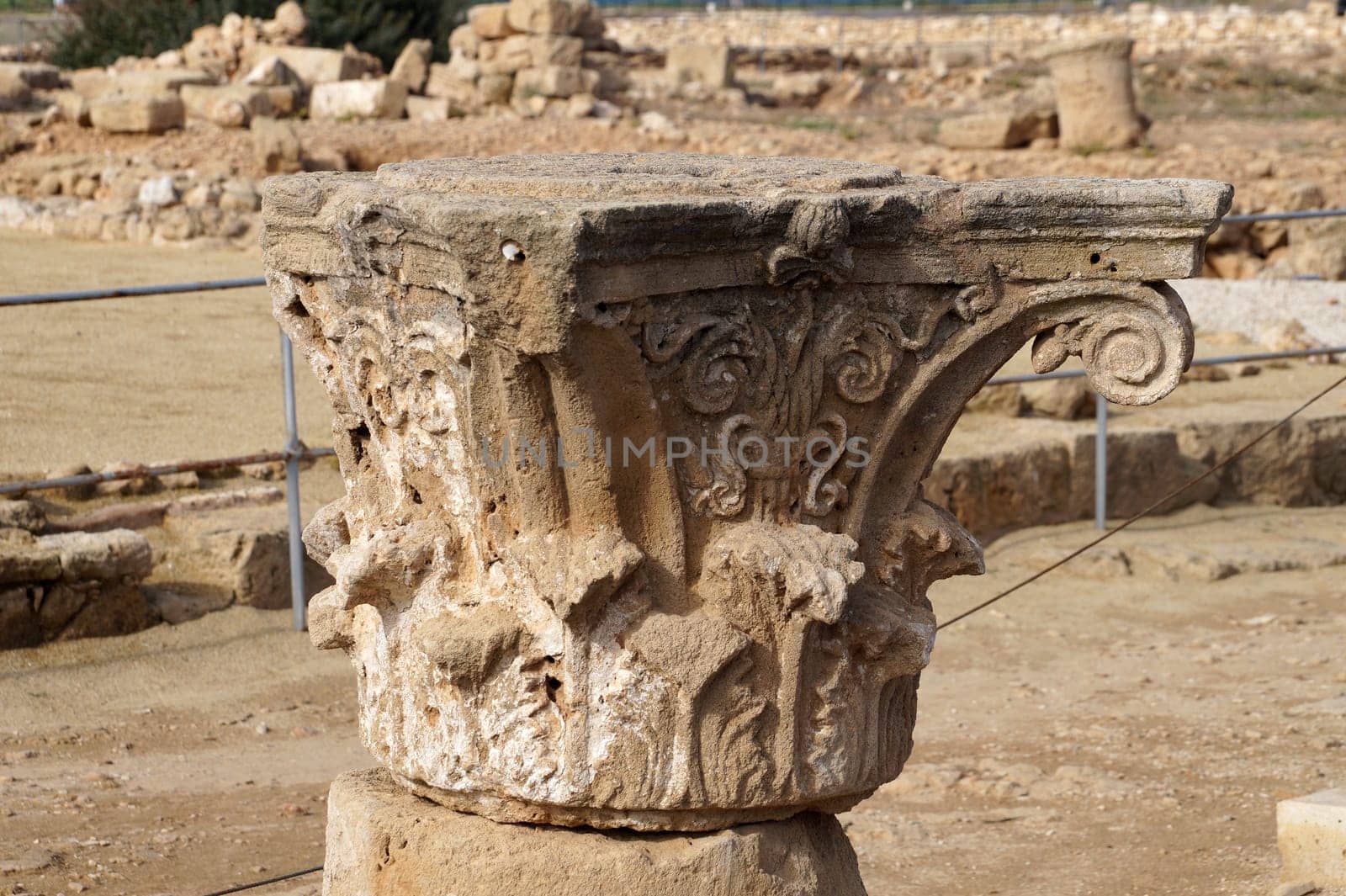 carved stone top of an ancient temple column in the Historical Park in Paphos, Cyprus.