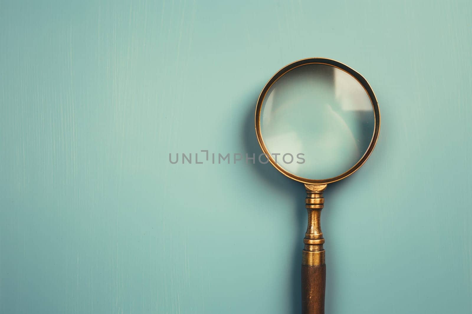 Magnifier magnifying glass with zoom lens for inspection and search tool closeup on blue background