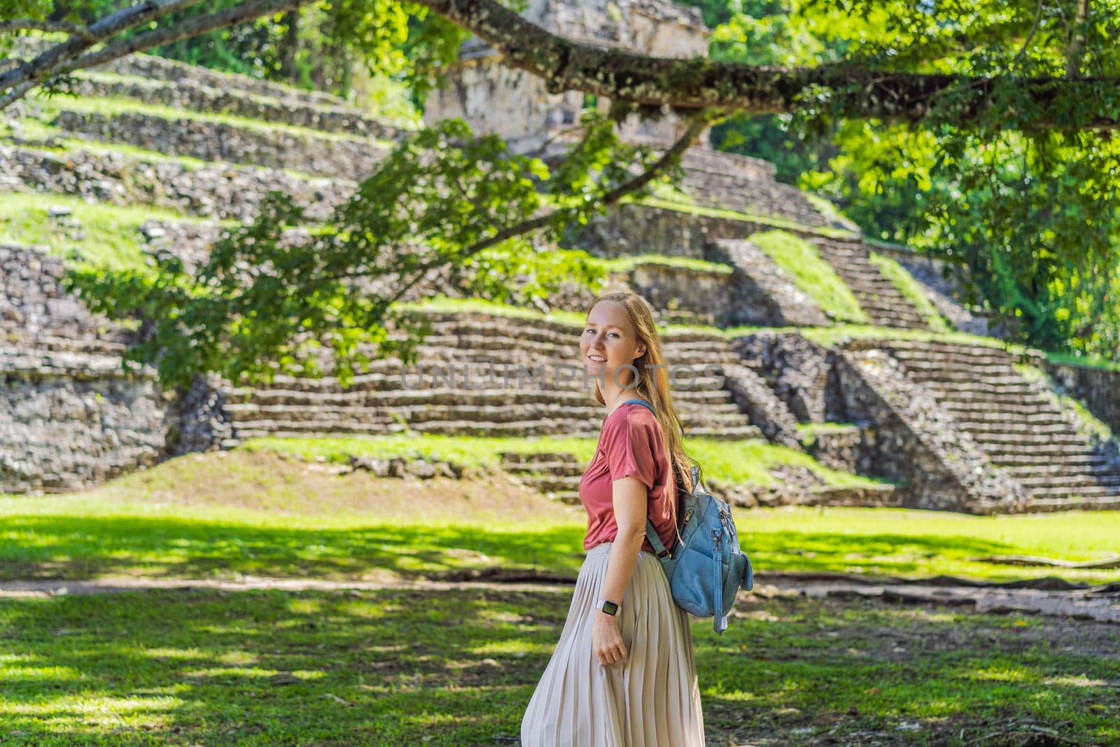 Female tourist exploring the ancient pyramids of Palenque, Mexico, surrounded by dense jungle. Cultural heritage and adventure travel concept.