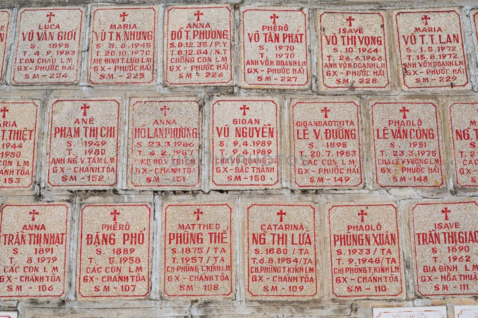 Tombstones of deceased Vietnamese near the Christ the King Cathedral also called Nha Trang Cathedral or Stone Church in Asia. Nha Trang, Vietnam - August 22, 2024