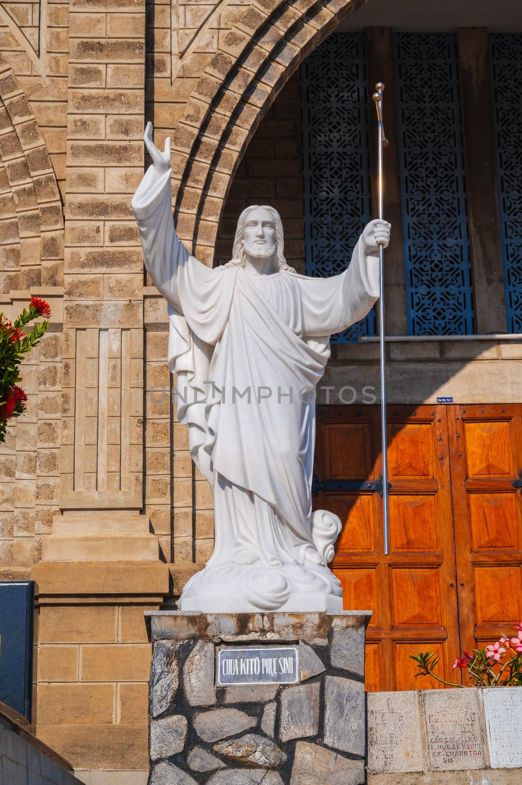 Sculpture of Jesus Christ in the square of Nha Trang Cathedral or Stone Church or Christ the King Cathedral in Asia. Nha Trang, Vietnam - August 22, 2024