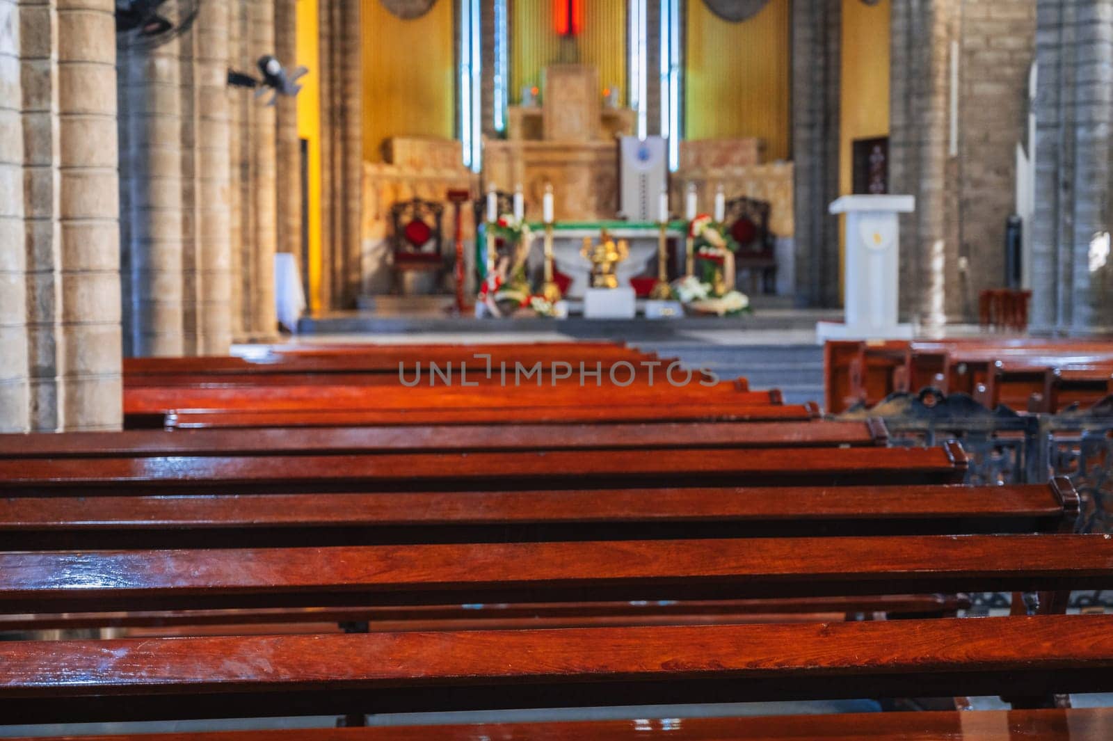 Wooden benches inside the Catholic Cathedral in Nha Trang in Vietnam in Asia