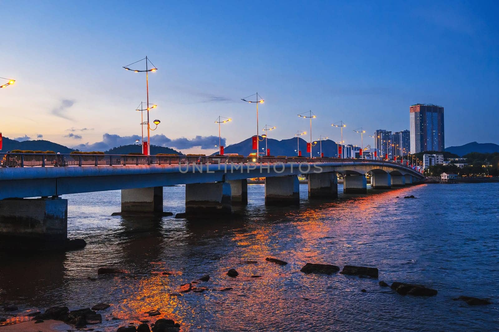 Tran Phu Bridge over the Cai River in Nha Trang at summer evening. Panorama of Nha Trang city in Vietnam