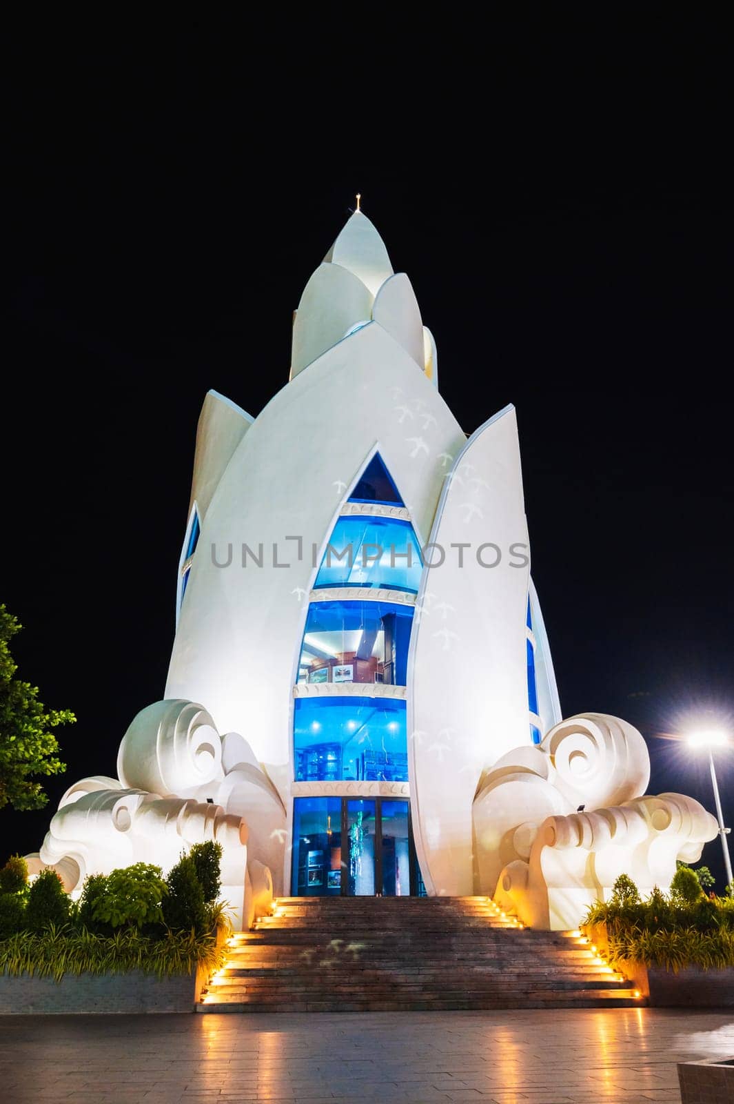 Landmark white Lotus Tower or Thap Tram Huong Tower in Nha Trang city on central square at night in Vietnam