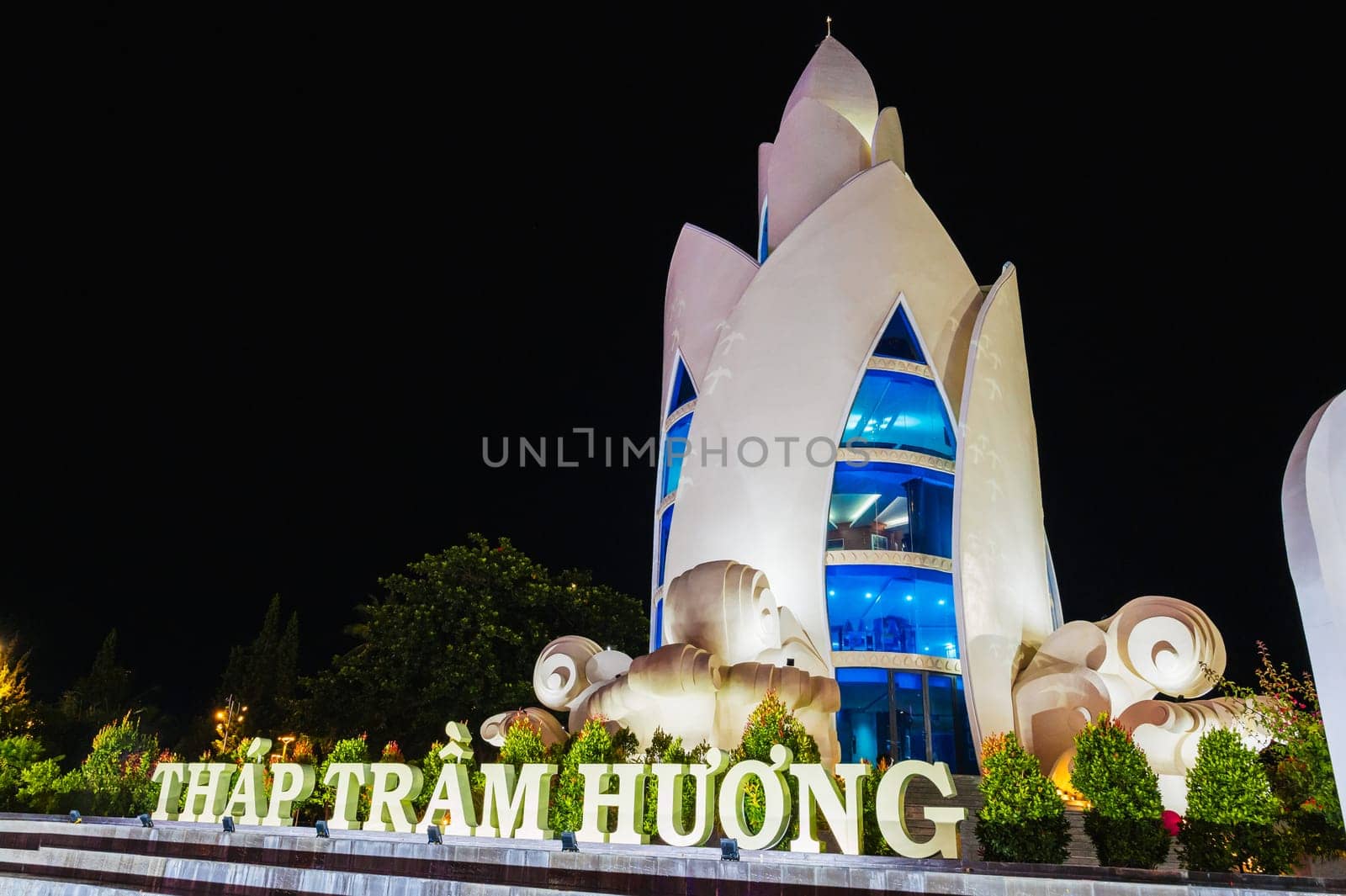 Landmark white Lotus Tower or Thap Tram Huong Tower in Nha Trang city on the waterfront at night in Vietnam