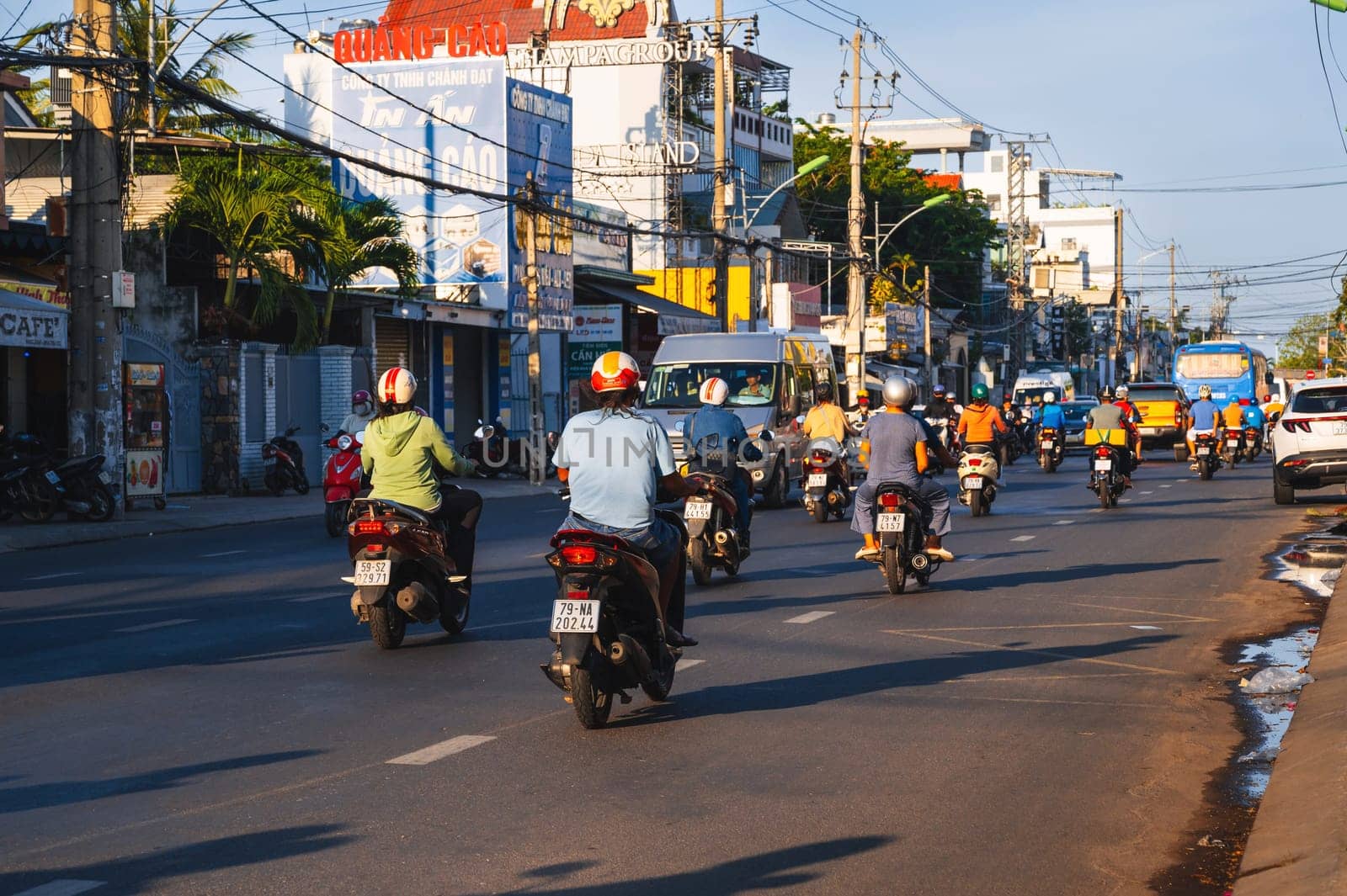 Motorbike traffic on the road in a city in Asia in the summer in day. Nha Trang, Vietnam - August 22, 2024