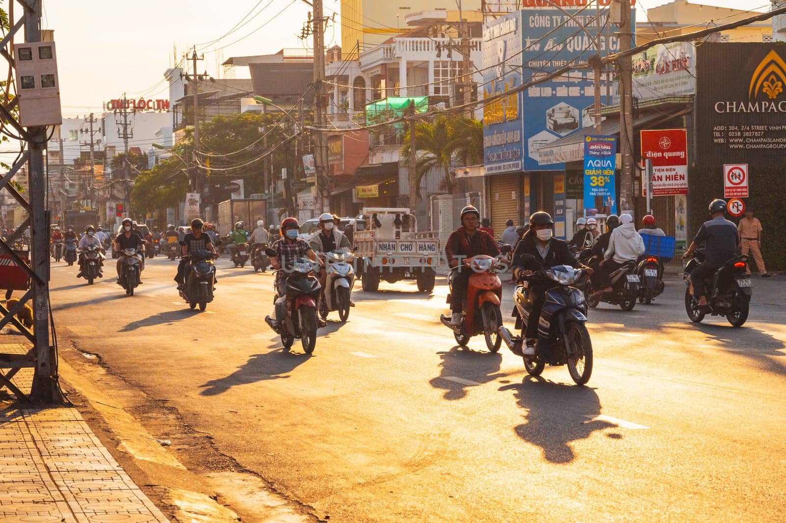 Motorbike traffic on the road in a city in Asia in the summer morning at dawn. Nha Trang, Vietnam - August 22, 2024