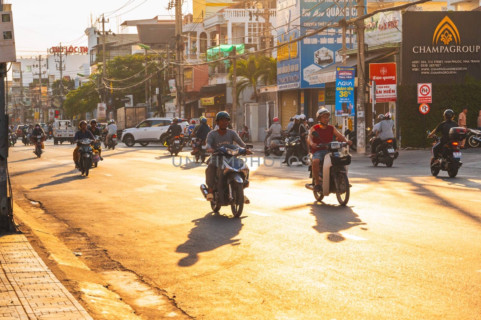 Motorbike traffic on the road in a city in Asia in summer morning at sunrise. Nha Trang, Vietnam - August 22, 2024