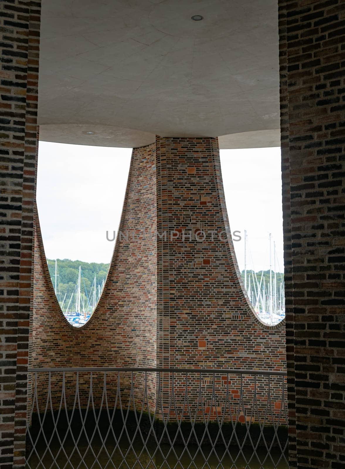 The iconic Fjordenhus between two houses in the harbour basin of Vejle, Denmark, view from insite to outdoor