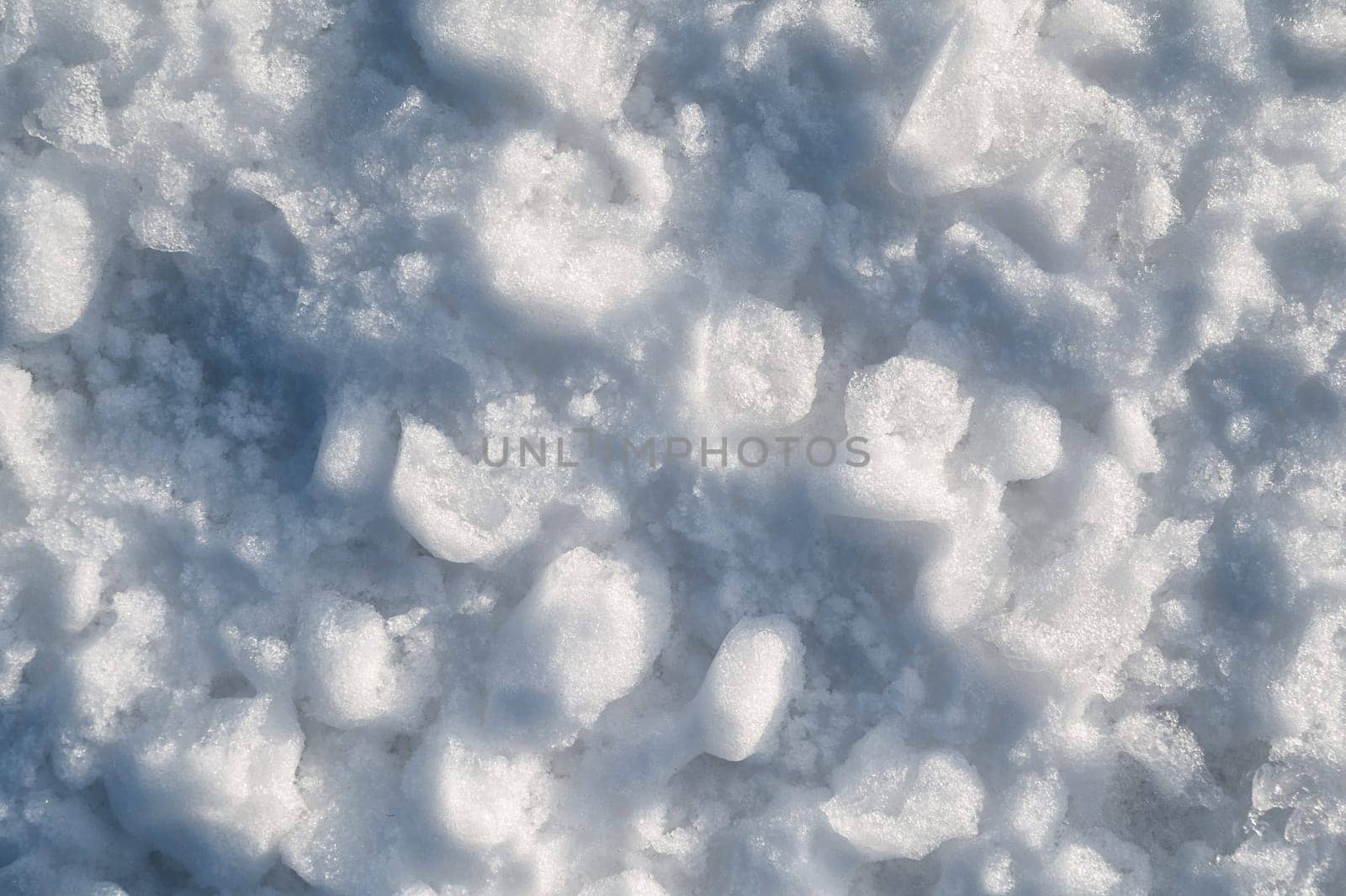 Background with texture of white snow on a snowdrift on a cold winter day
