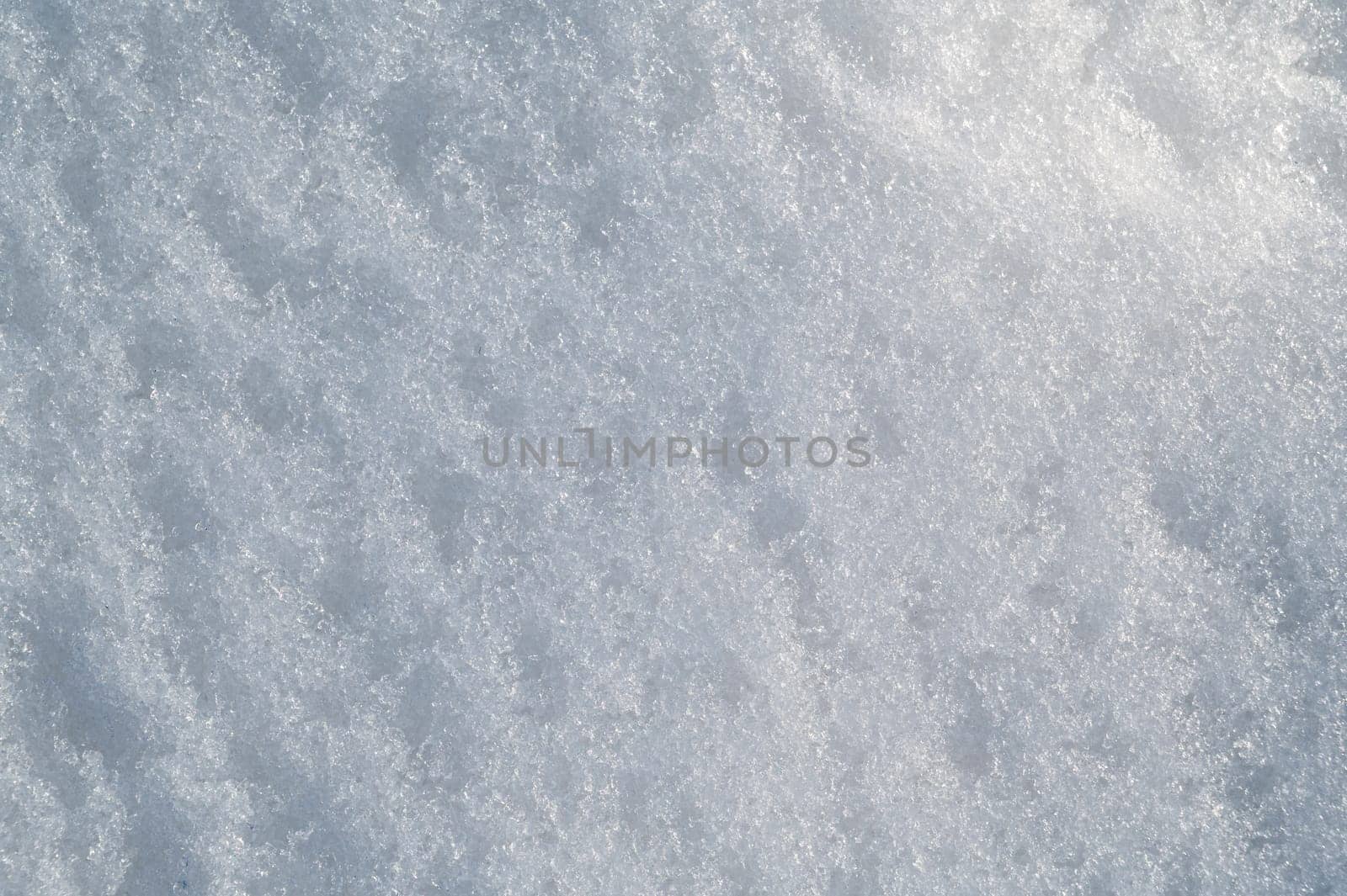 white texture of snow on a snowdrift on a cold winter day