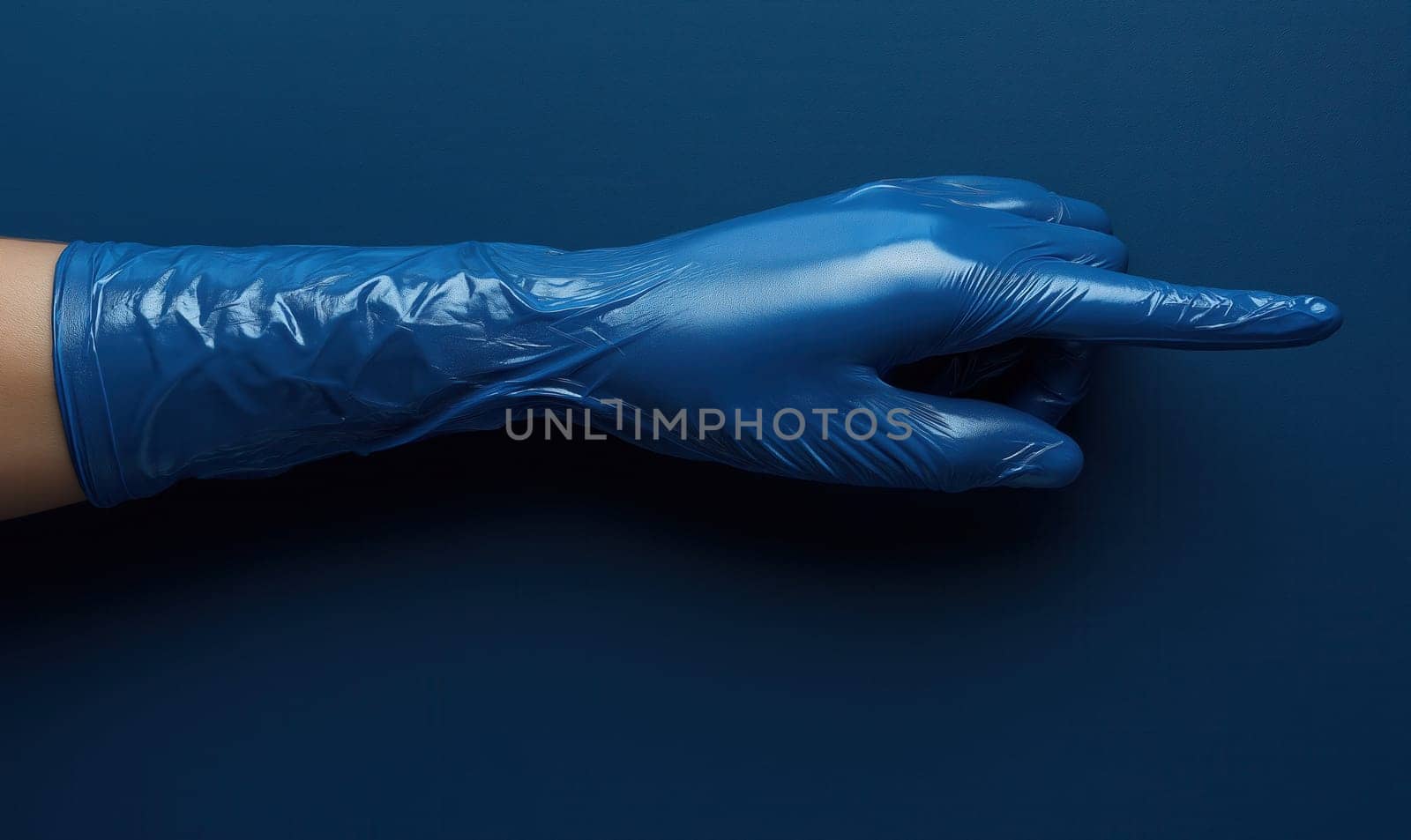 Hand in a blue latex glove on a blue background. Selective focus.
