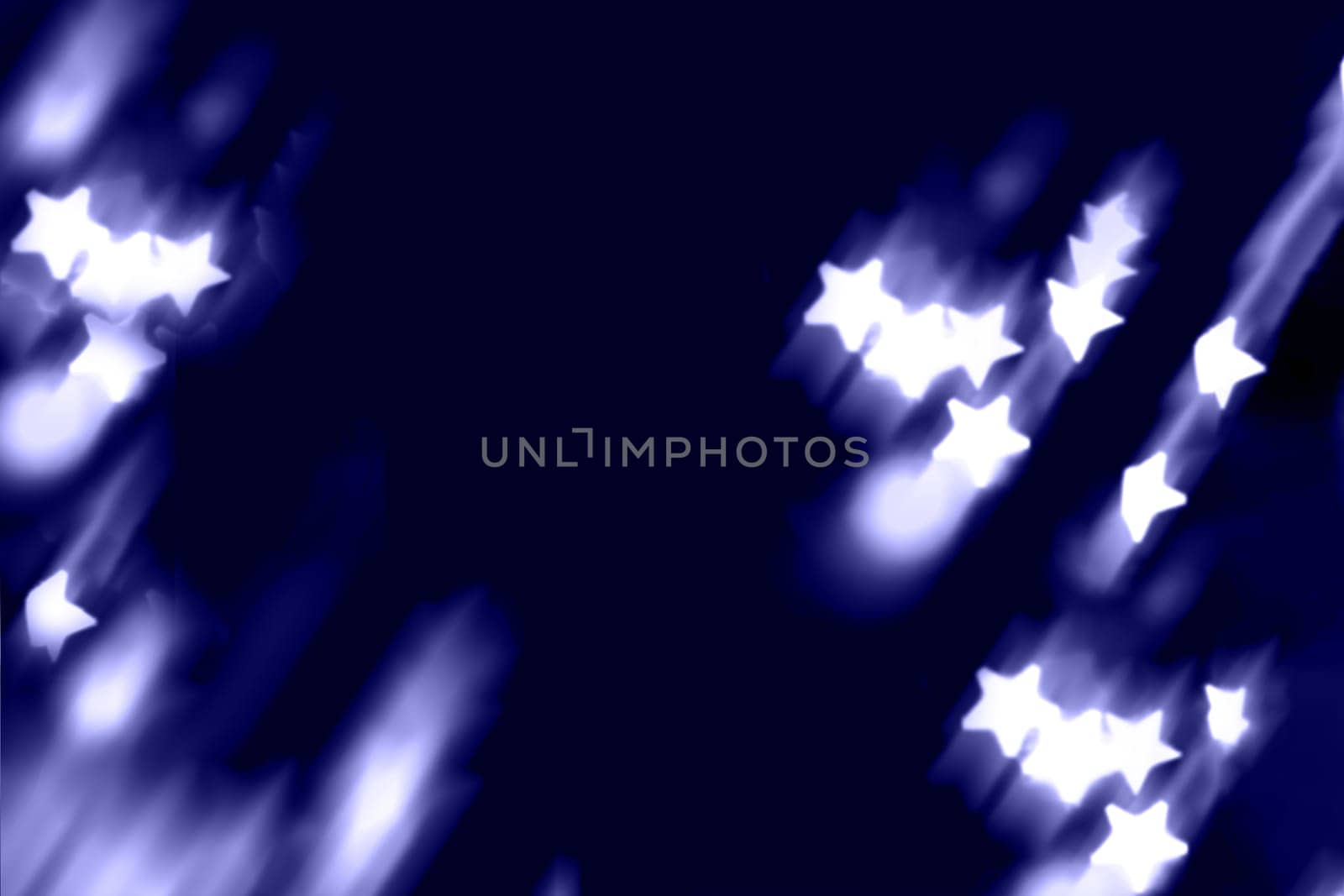 Blurry garland lights on a dark background. Festive Christmas and New Year background. Soft focus.