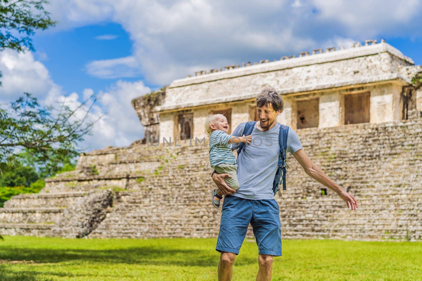 Mother with his toddler son exploring the ancient pyramids of Palenque, Mexico, surrounded by dense jungle. Cultural heritage and adventure travel concept.